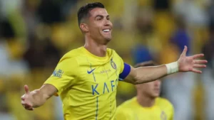 Cristiano Ronaldo celebrating his penalty goal against Al-Wehda, arms outstretched