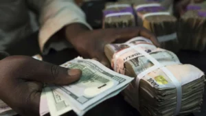 Naira depreciates to N1,700 per dollar in parallel market while gaining ground in NAFEM